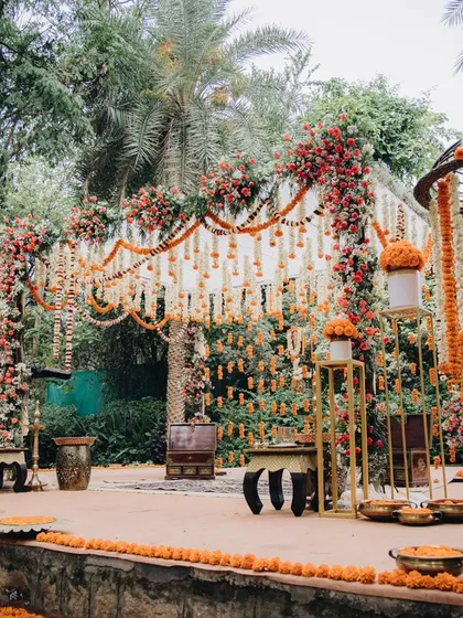 We designed this spectacular floral archway and mandap for a grand outdoor wedding, using a mix of marigolds and roses to create a truly memorable entrance.