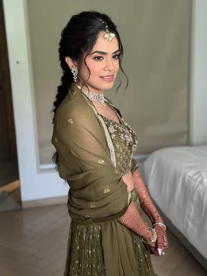 A side profile showing the soft, blended makeup and the intricate hairstyle. This is effortless elegance for a pre-wedding event.