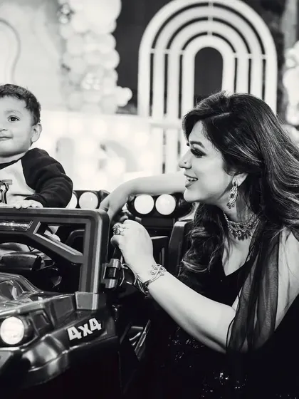A sweet black and white moment between a mother and her son at his birthday party.