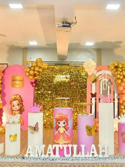 A princess theme with a shimmering gold backdrop and cutouts of different princesses.