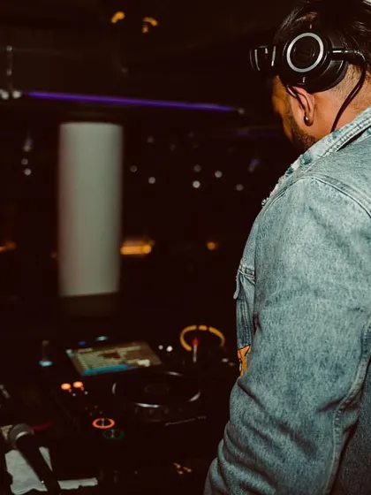 Dance with the groove. A shot from behind the decks, showing off my style. I believe a DJ's look is part of the whole performance and experience.