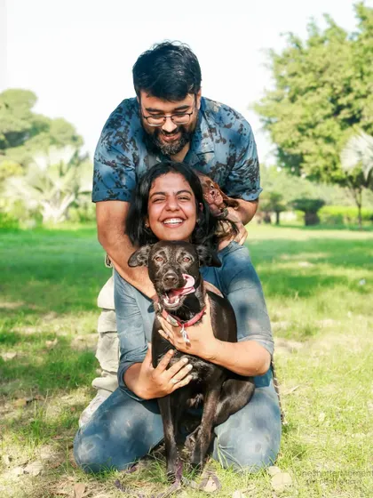 If you look closely, you'll see another cute face! This fun family photo perfectly captures the playful dynamic of life with two dogs.