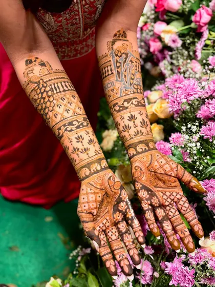 A stunning bridal design featuring a personalized logo of the couple's initials, surrounded by traditional patterns and lotus motifs.