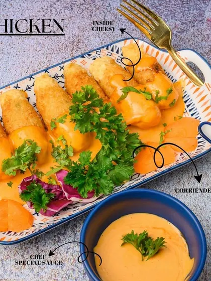 A detailed look at our Sticky Chicken, highlighting its key components. The chicken is crunchy on the outside, filled with cheese on the inside, and coated in our chef's special sweet and savory sauce.