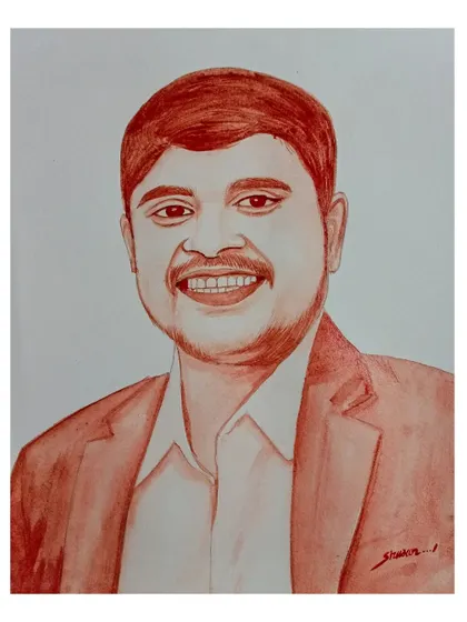A professional-style blood portrait of a smiling man in a suit jacket.