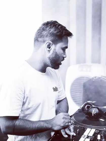 A black and white shot capturing me in the zone. DJing is my passion, and these moments of intense focus are where the magic happens.