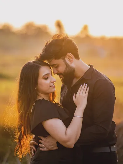 An intimate embrace during a golden hour pre-wedding shoot. The warm sunlight and natural setting make this a deeply romantic and beautiful photograph.