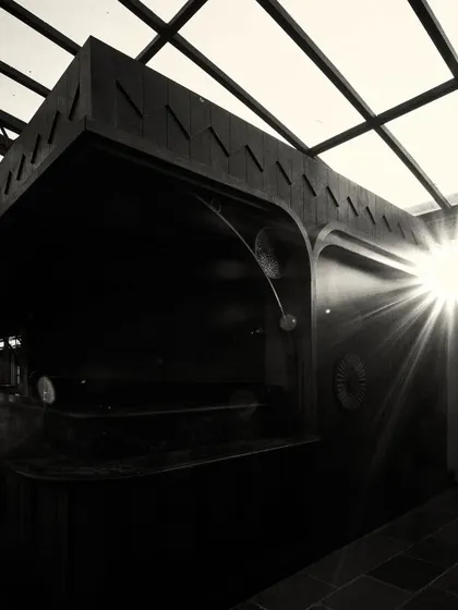 A sunburst effect as light streams into the dark, wood-paneled bar area, creating a moment of high drama.