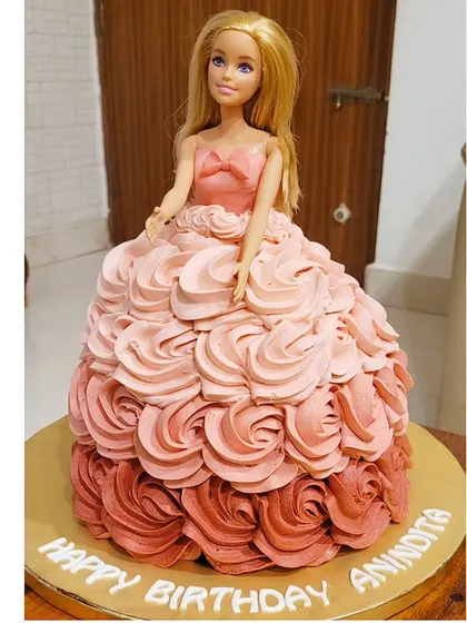This Barbie is made of cake! A classic doll cake where the dress is made of beautiful ombre pink buttercream rosettes.