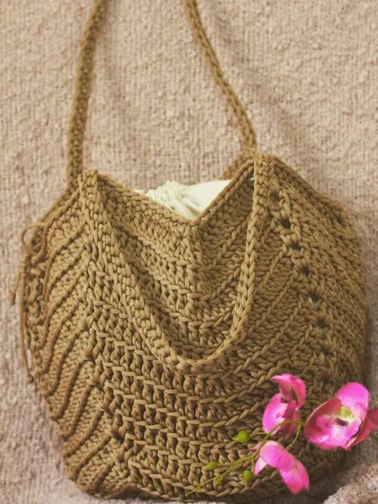 This tote bag has a unique chevron pattern and a drawstring lining to keep your belongings secure.