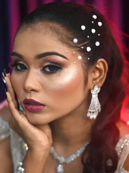 A close-up of the glam party look, with pearl hair accessories and a sharp, smokey eye. This showcases my skill in creating trendy and high-fashion looks.
