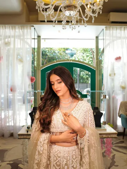 The full view of the stunning ivory lehenga, which pairs perfectly with the soft and elegant makeup.