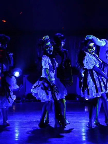 A moment of spooky storytelling from our kids' contemporary horror-themed act. The dark blue lighting and creative costumes set a mysterious and captivating mood.