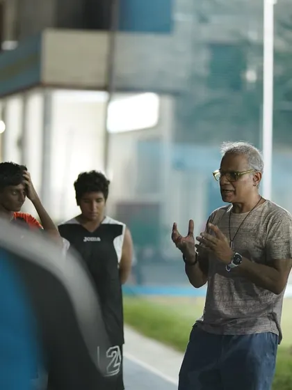 An experienced coach sharing his wisdom with our players during a basketball skills workshop. These moments of mentorship are invaluable.
