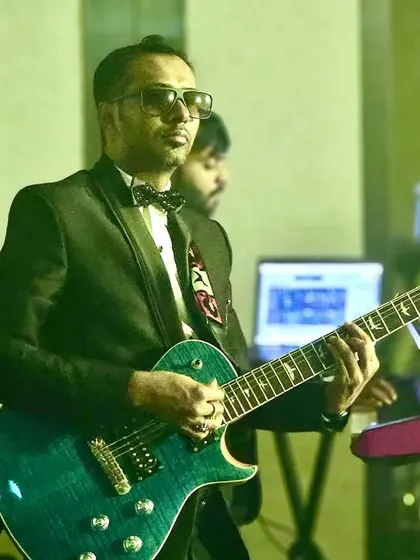 Our guitarist in his element during a performance. Each musician is a seasoned professional, dedicated to delivering a flawless show.
