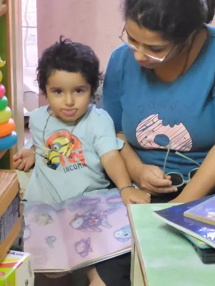 A mother and child share a quiet moment with a picture book. Reading together is one of the best ways to bond and build a lifelong love for stories.