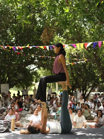 A classic 'throne' pose in Acro Yoga, performed for the Zenfest crowd. It looks simple, but it's built on a foundation of solid communication and balance.