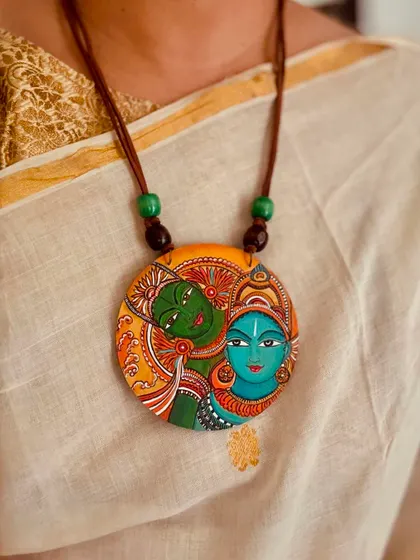 Another view of the Kerala mural pendant, showcasing its vibrant colors and artistic detail.