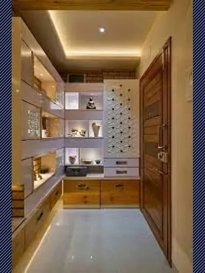 A narrow hallway transformed into a storage area with custom, full-height, backlit shelving and drawers.