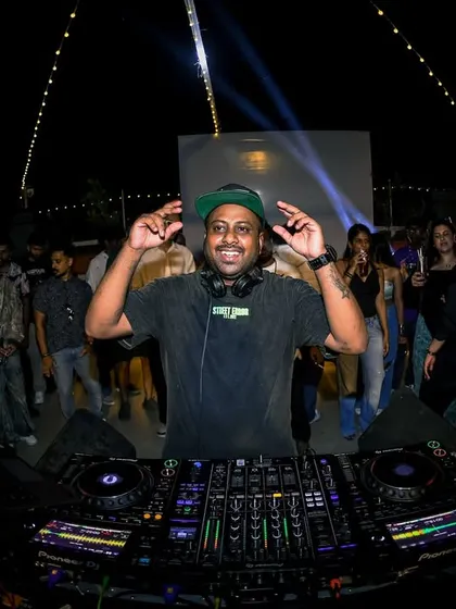 A guest DJ enjoying the moment behind the decks. It's about having fun while you work.