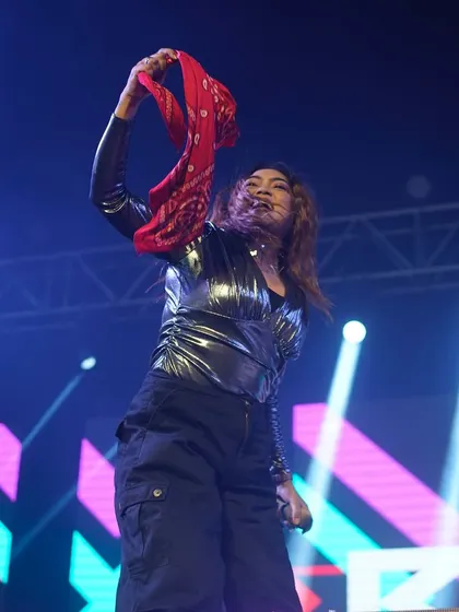Waving a red bandana to hype up the crowd during a New Year's 2025 performance. The energy was electric.