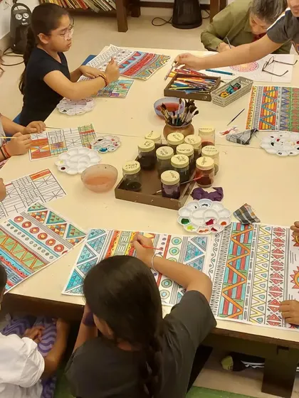 Students working on their African Kente cloth patterns. The tables are always full of color, supplies, and the focused energy of artists at work.
