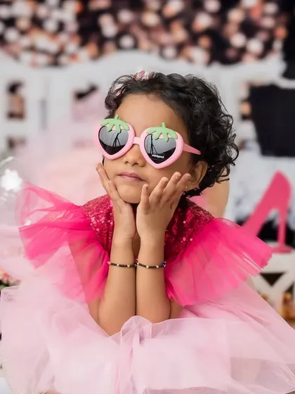 A sassy and fun pose from the older sister during their Barbie-themed sibling photoshoot.