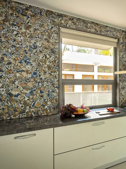 This kitchen showcases a bold design choice with a unique, patterned tile backsplash. It demonstrates how even functional spaces can become a canvas for personal expression and artistic flair.