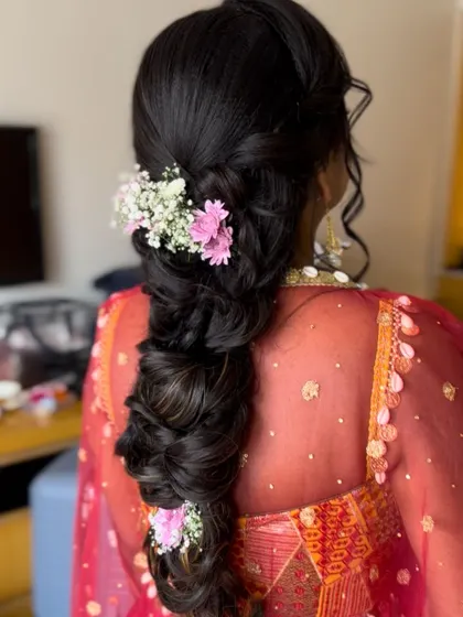 A soft, romantic pull-through braid decorated with delicate baby's breath. This is a perfect style for an engagement or daytime event.