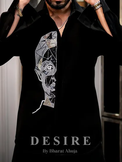 Adjusting the cuffs on the abstract face shirt. Even the smallest details are designed with style and confidence in mind.