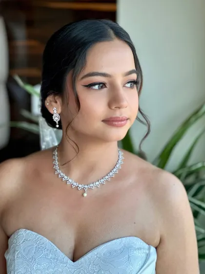 The soft, natural light enhances Beracah's radiant complexion. Her makeup feels light and breathable, allowing her natural beauty to shine through on her special day.
