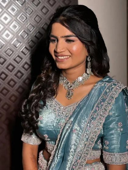 This bride chose a beautiful powder blue lehenga for her engagement. The makeup is soft and dewy, with a focus on glowing skin.