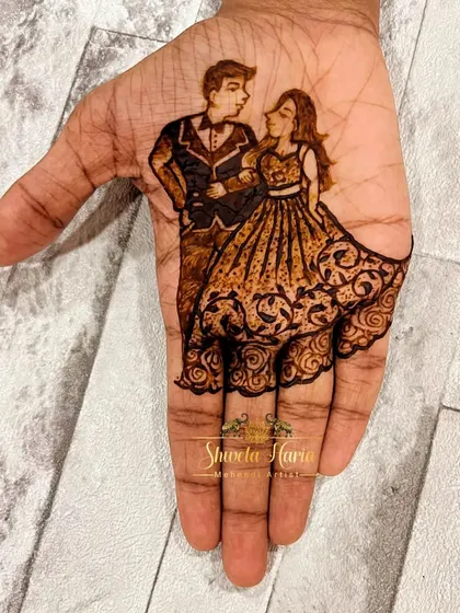 A minimalist yet elegant engagement design. This artwork focuses on the palm, featuring a beautifully detailed portrait of the couple in western attire, with the bride's flowing gown created from delicate henna patterns.