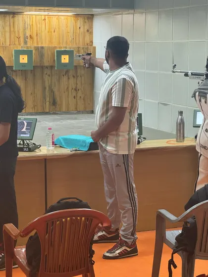 An adult shooter takes aim during a practice session. My coaching is open to all age groups, from young children to senior citizens who are passionate about the sport.