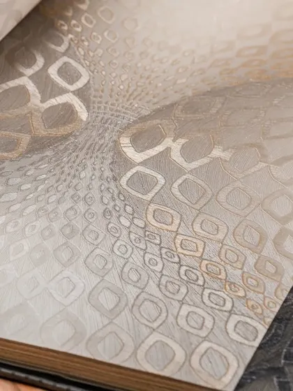 A mesmerizing geometric pattern that creates an optical illusion of depth. This wallpaper in neutral tones is perfect for a contemporary space that needs a focal point.