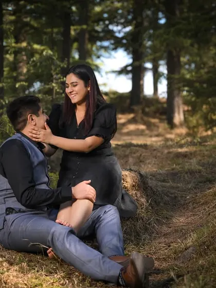 An intimate and tender moment on the forest floor. This candid shot captures a quiet connection, away from everything, surrounded by nature.