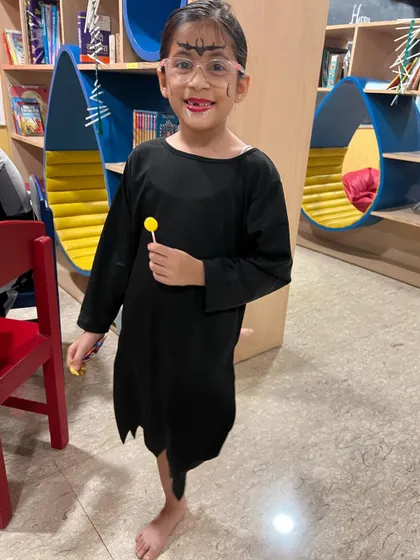 A spooky girl in her Halloween costume, ready to enjoy her lollipop treat. We encourage all the kids to come dressed up for our party.