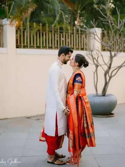 An intimate portrait of the couple, their foreheads touching, in a moment of quiet connection.