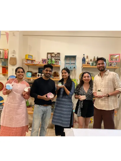 A group of happy creators from my eco-resin workshop, holding up the unique items they made.