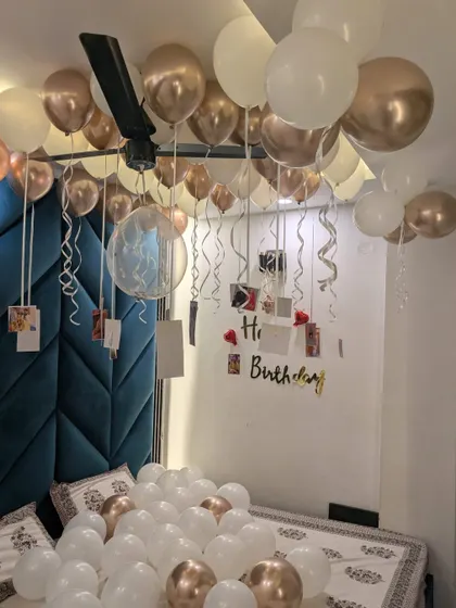 This view highlights the "Happy Birthday" sign and the photo memories hanging from the ceiling balloons.
