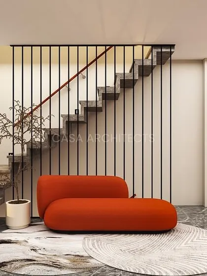 A render of a modern entryway with a minimalist staircase, a bold orange sofa, and a mix of marble flooring and wood accent walls.