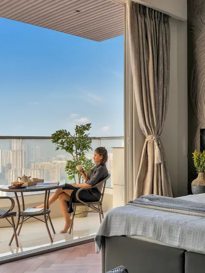 I believe a home should feel like a getaway. This bedroom, opening onto a balcony with a sweeping city view, is styled to create a staycation state of mind. It’s a peaceful escape where you can pause and enjoy the moment.