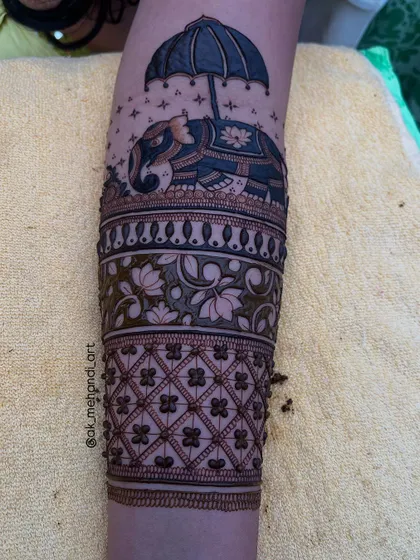 A full bridal arm design featuring the elephant with umbrella motif. It adds a touch of royal elegance to the overall look.