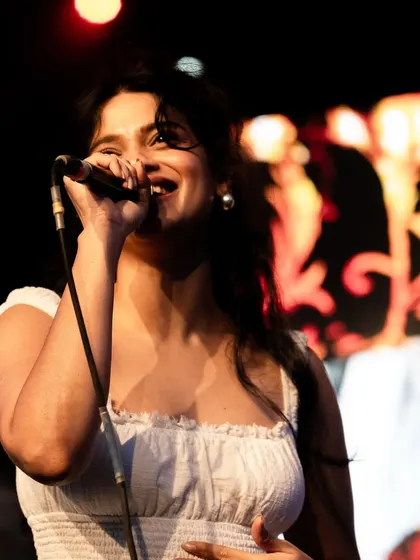 A profile shot of me singing during the concert. Performing live on a festival stage allows me to share my passion for music with a huge crowd.