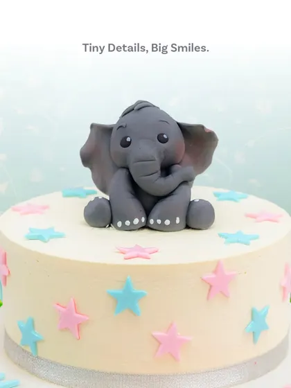 A detailed shot of the handcrafted elephant topper, showcasing its sweet expression and tiny details.