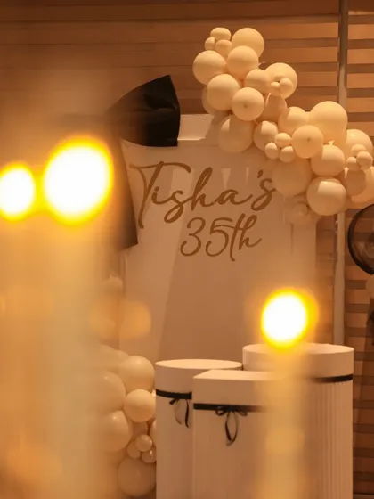 An atmospheric shot of the birthday setup, with the warm glow of candles in the foreground.