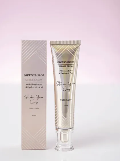 A clean, minimalist product shot of a strobe cream tube and its box against a soft pink background. This is ideal for e-commerce or catalog use.