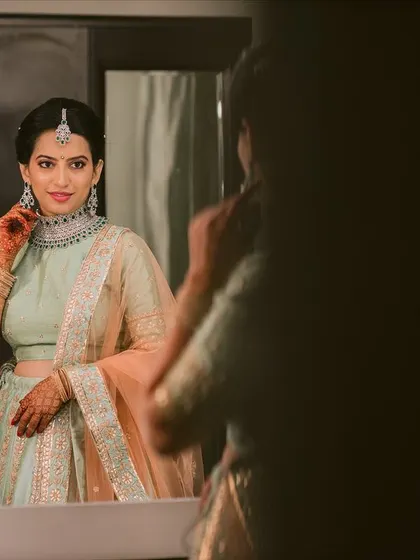 The final touches. A candid shot of the bride adjusting her earrings, confident and ready for her engagement ceremony.
