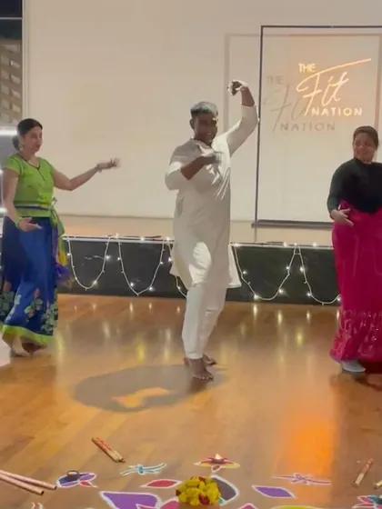 Teaching some Garba steps to the participants on stage.