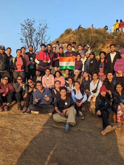 A patriotic group photo with the Indian flag on the Skandagiri trail.